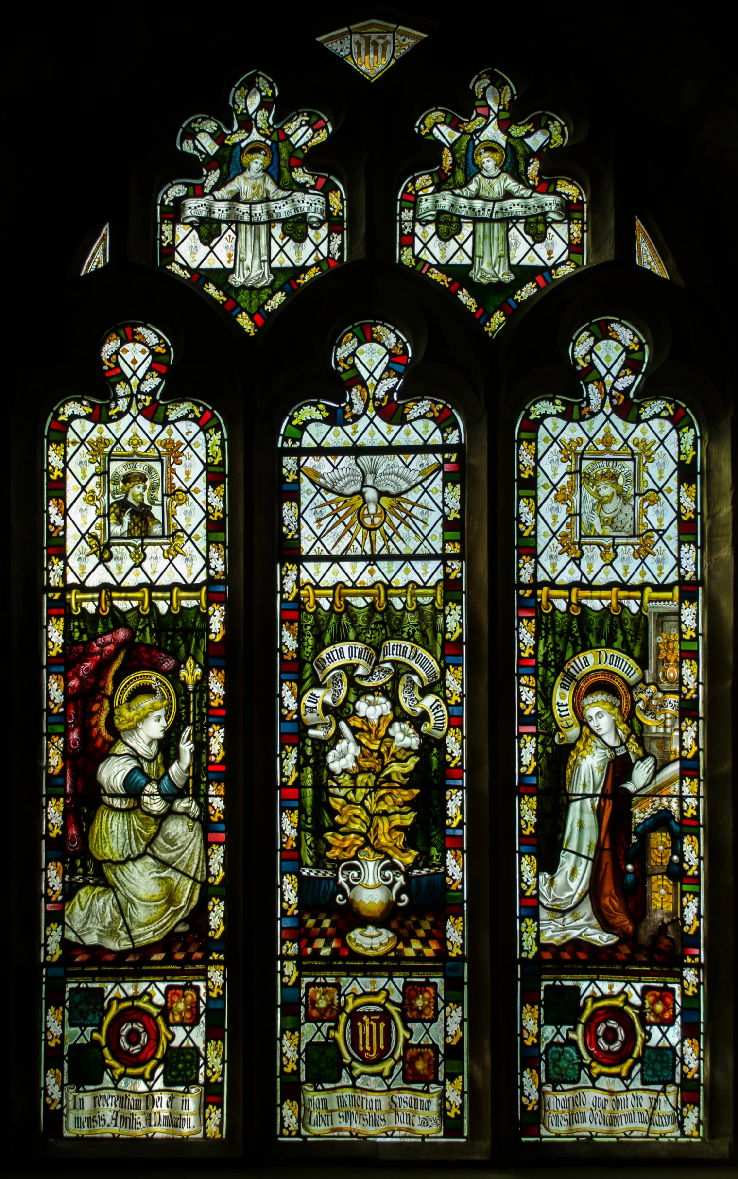 a very tall window with stained glass decorations