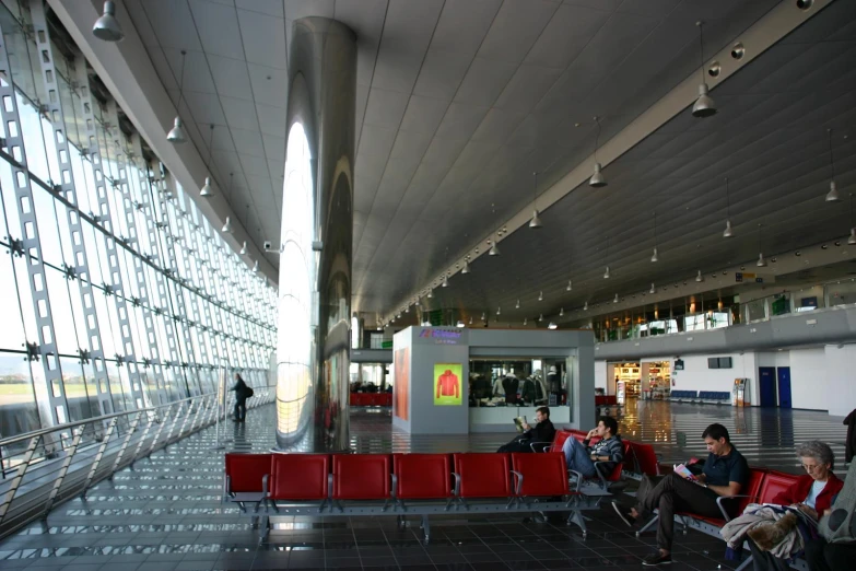 passengers wait in the terminal waiting for their baggage