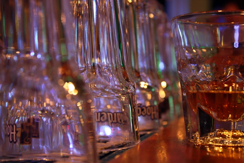 a line of glasses filled with various liquor