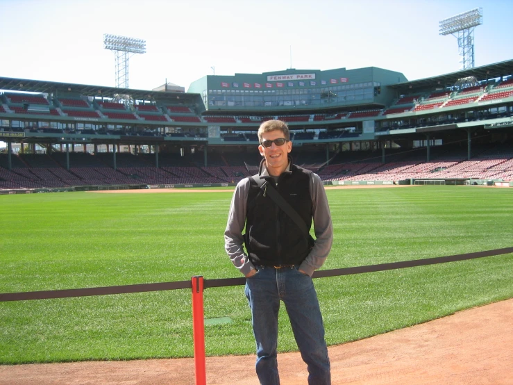 a man posing on the edge of a baseball diamond