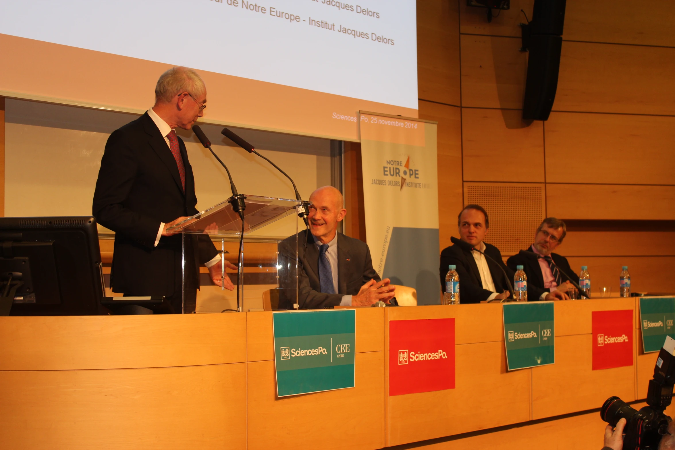 a person at a podium giving a speech in front of people