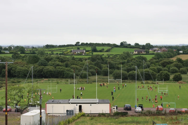 a large field with people playing soccer on it