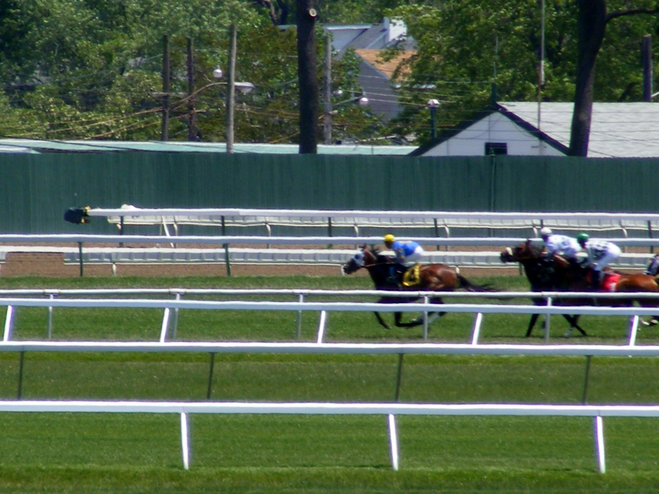 the people are racing horses through the track