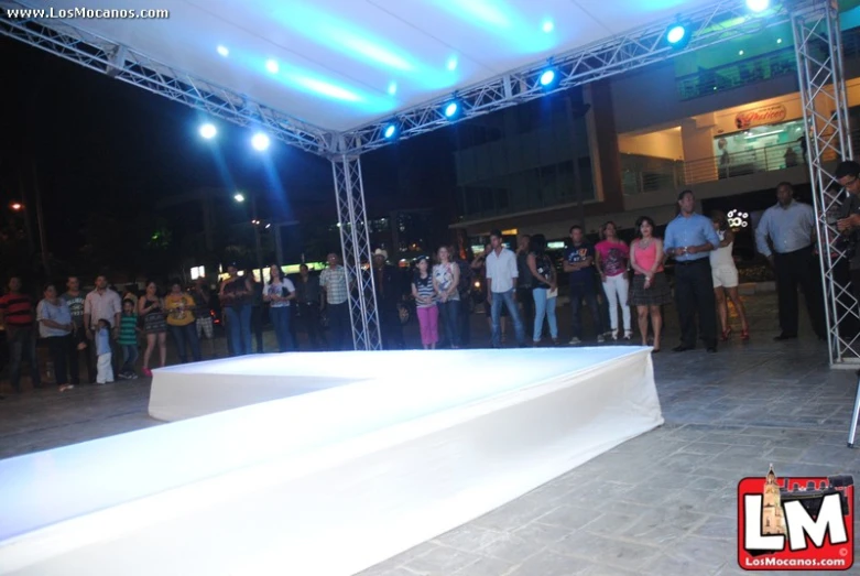 people standing in the middle of a stage at night