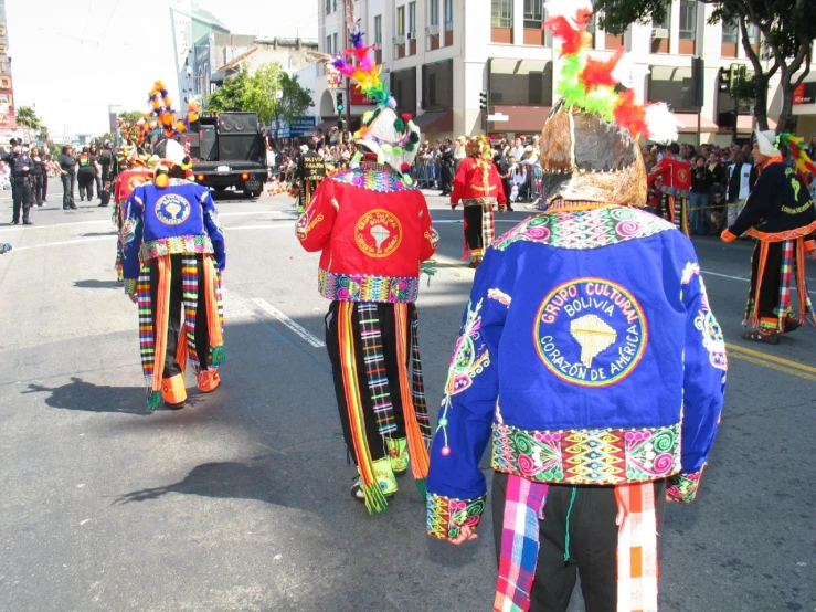 people wearing colorful clothing walking on the street