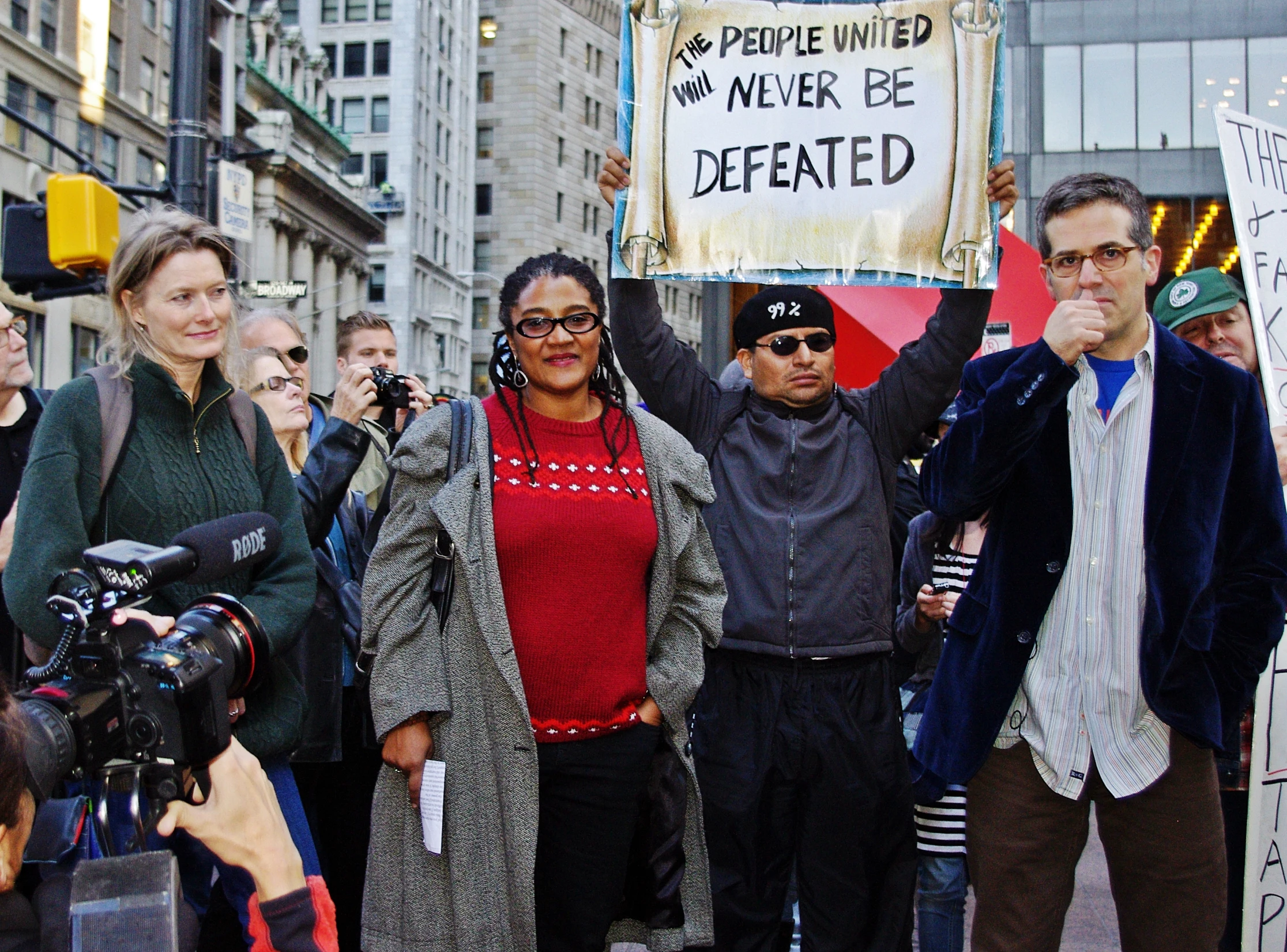 several people holding signs during the day, protesting