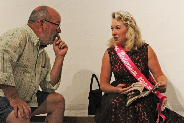 a woman sitting on a step while a man sits beside her