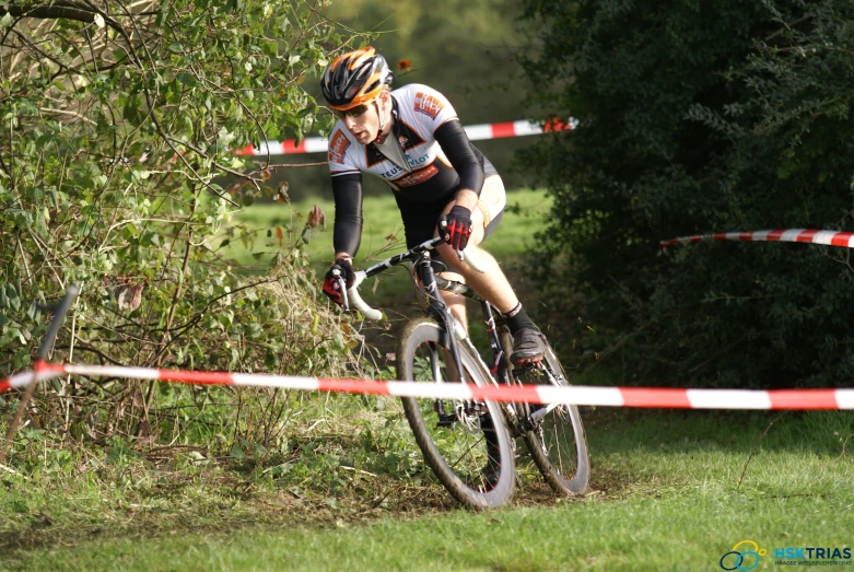 a cyclist going down a trail in the woods