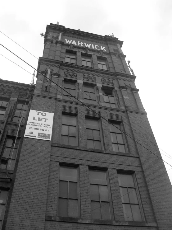 a tall brick building with two windows