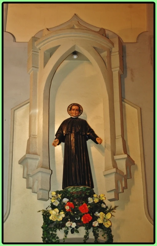 a statue of a woman standing in front of a building