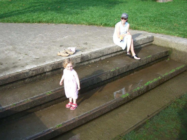 a woman and a small child sitting on stairs