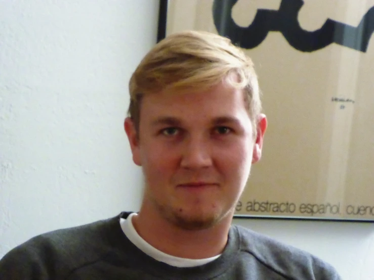 a person is standing by some posters on the wall