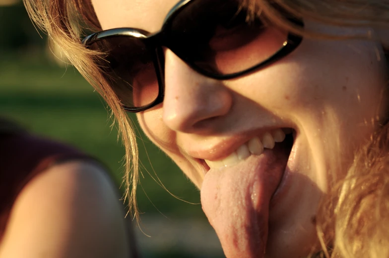 a women with her tongue hanging out giving a cute face