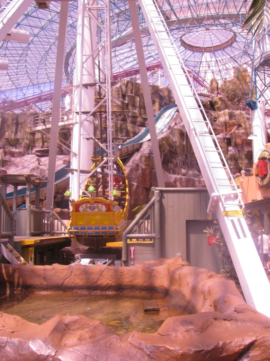 a yellow carnival ride rides through the air at the park