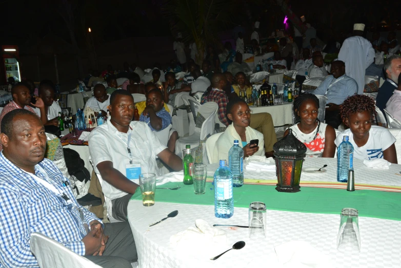 a large group of people sitting at a table