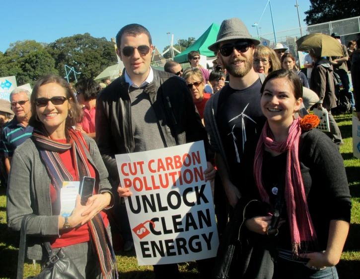 a group of people standing next to each other holding up signs