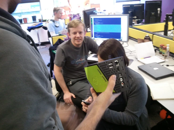 two people looking at a laptop together in an office