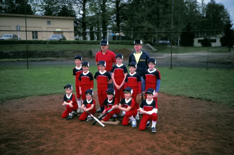 a little league team posing on the field in uniform