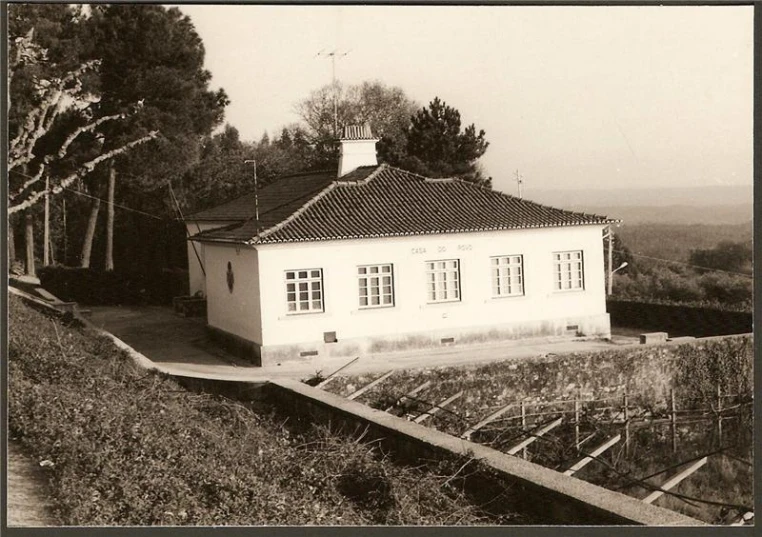 a small house with a white wall and windows