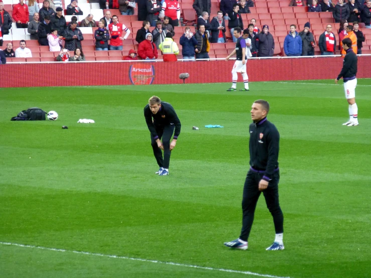 two men standing on top of a soccer field