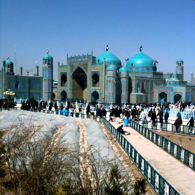 people in front of an ornately colored building with a blue dome