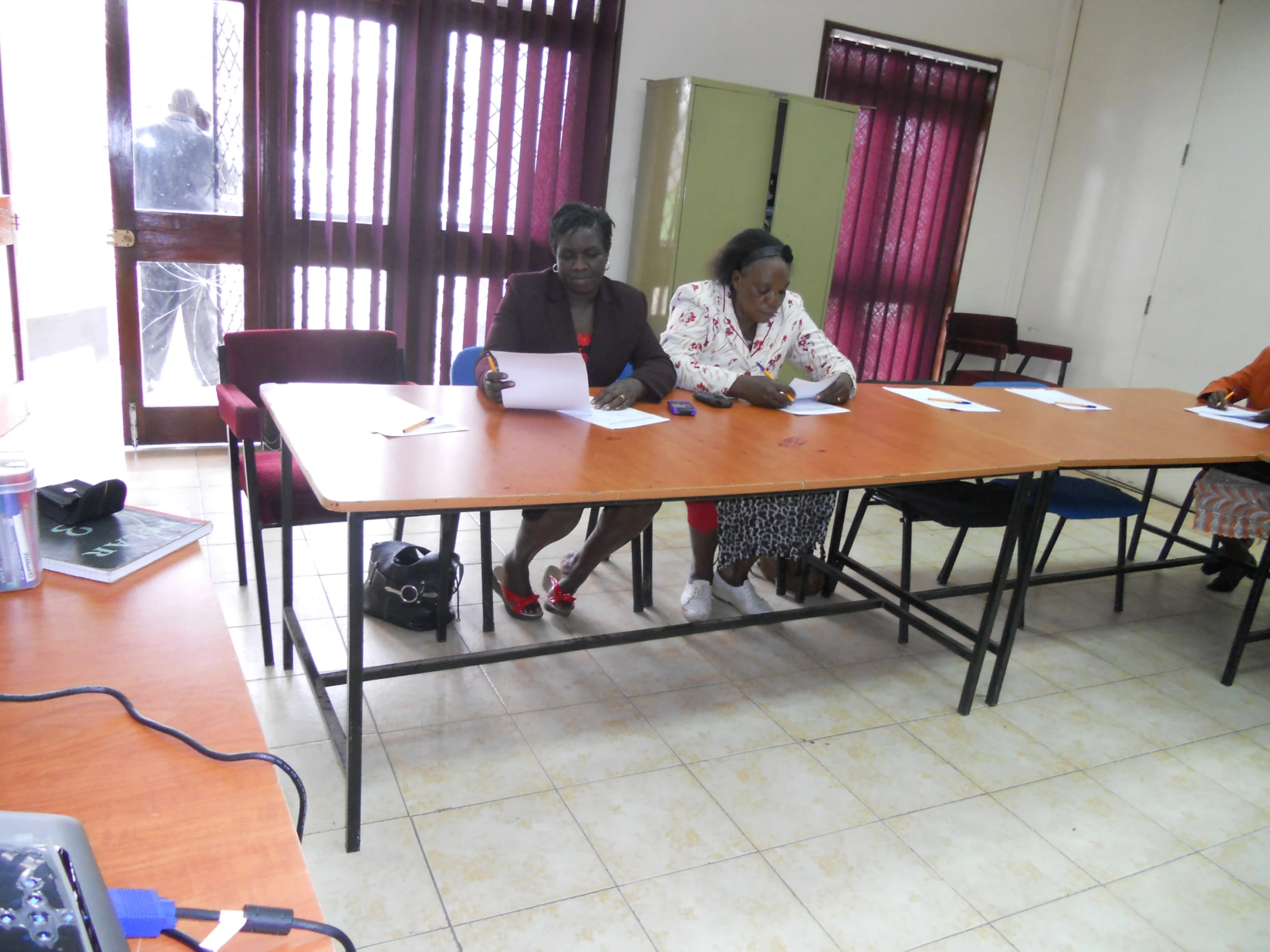 there are many women working on papers at the table