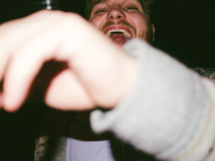 a person holds the end of a wine bottle