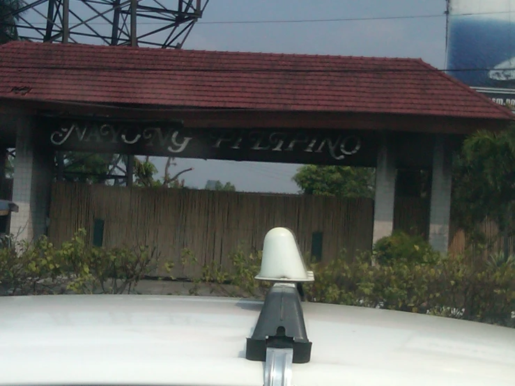 a small parking meter stands in front of a building