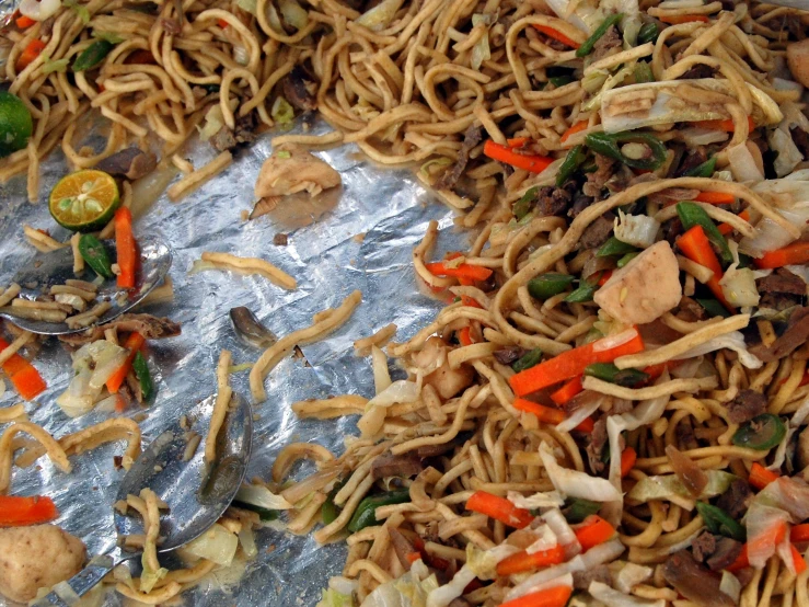 mixed vegetables and noodle on a piece of foil