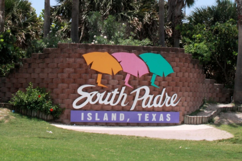 a large sign is shown in front of palm trees