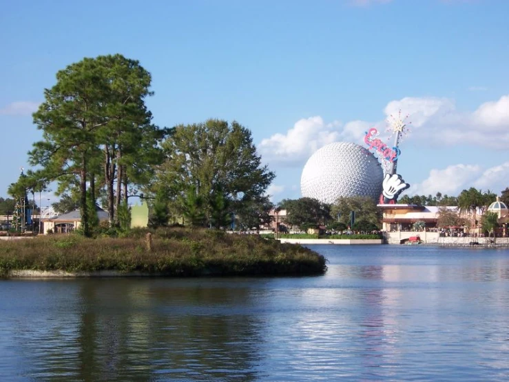 a giant statue with minnie in it in a water area next to a lake