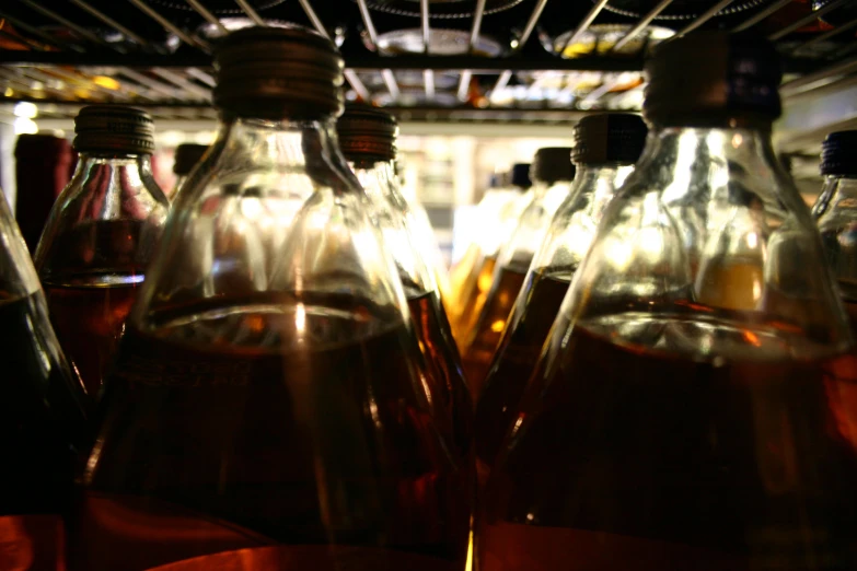 bottles of liquid are shown as they sit in a refrigerator