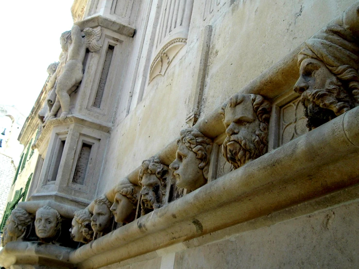 several heads are on the front and side of a building