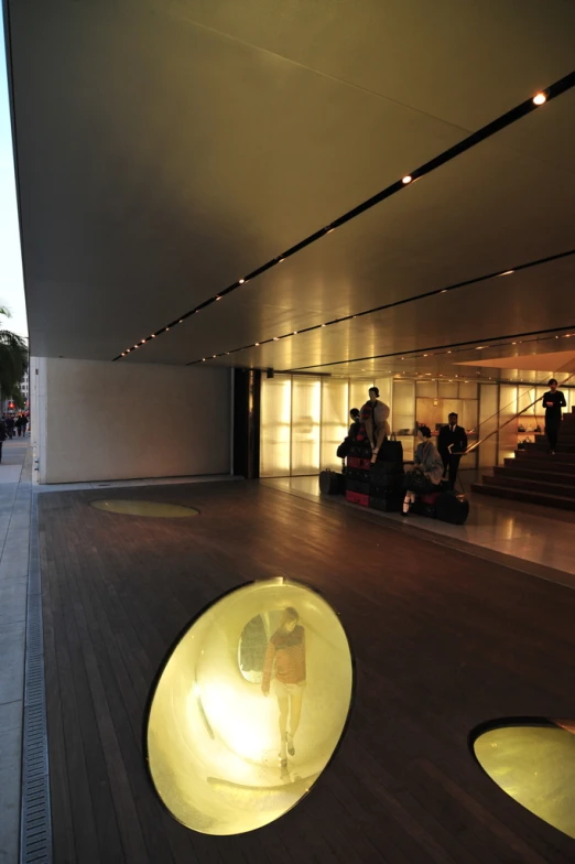 a group of people sitting on top of a wooden floor