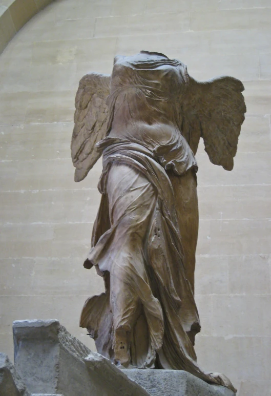 a statue of an angel holding a shield