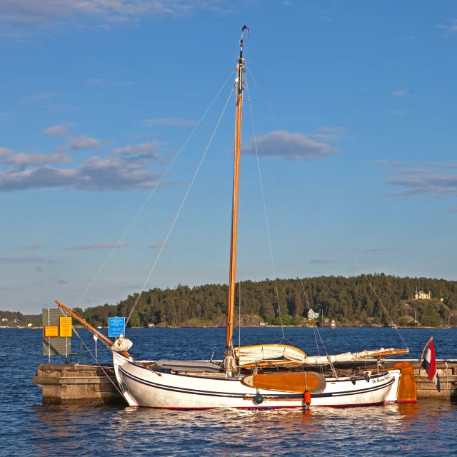 a boat floating in the water near a pier