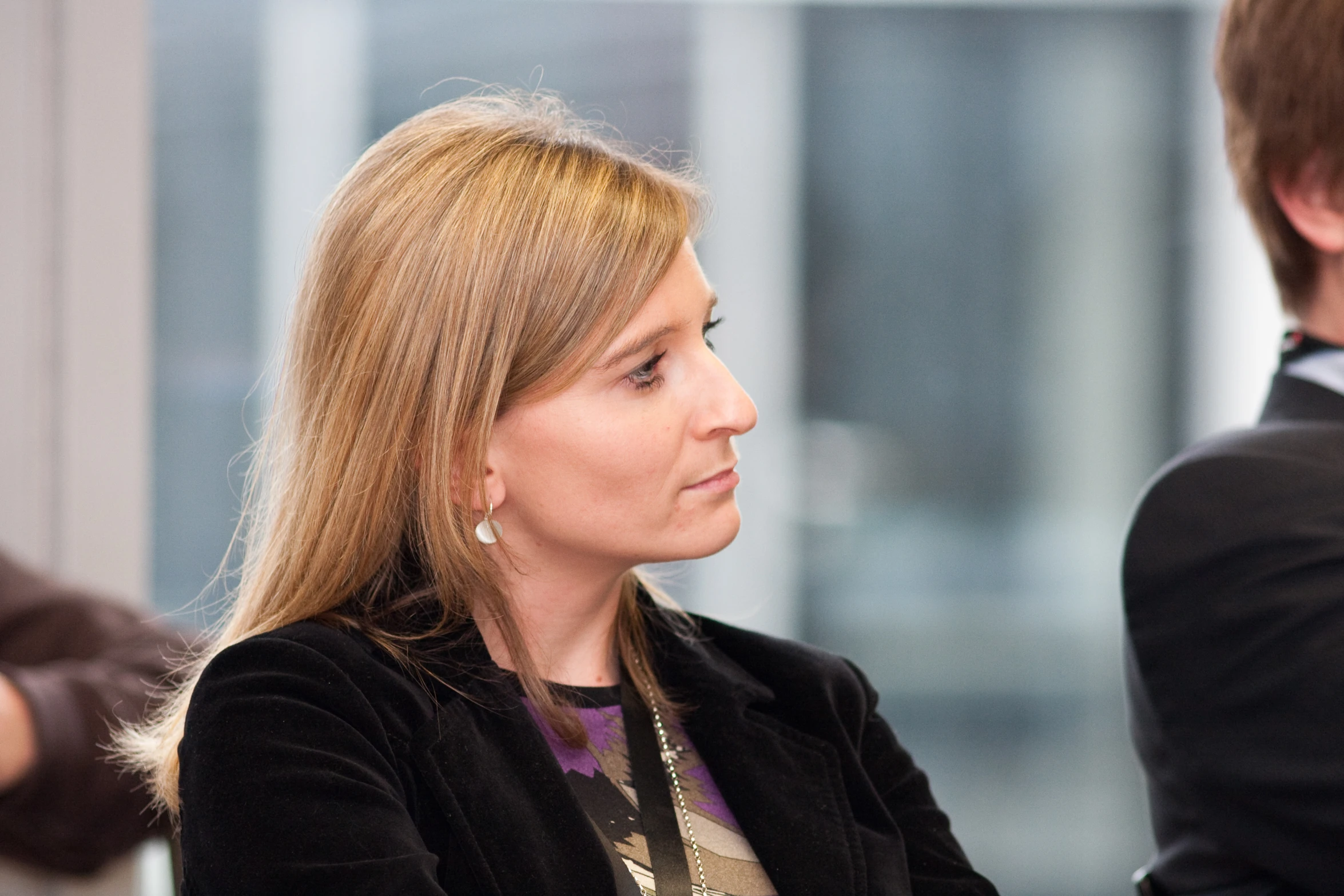 woman with a concerned look sits in an office building