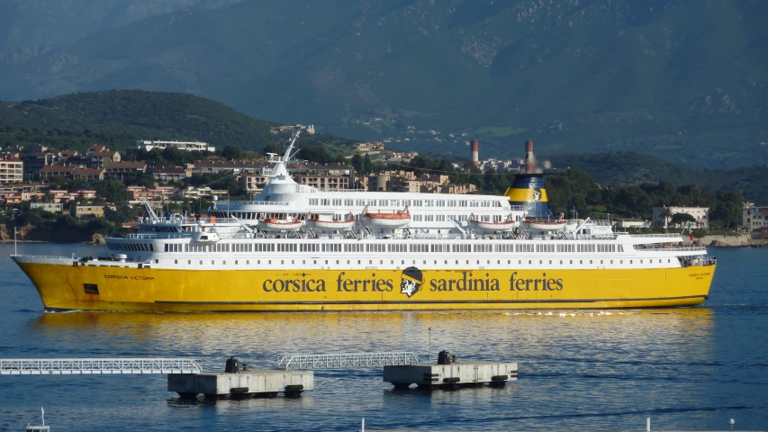 a cruise ship in the water in front of a town