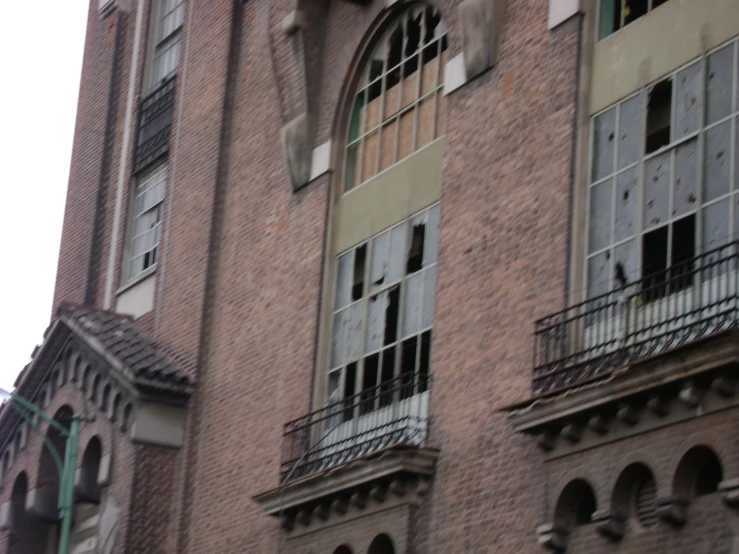 an old building is shown with broken windows