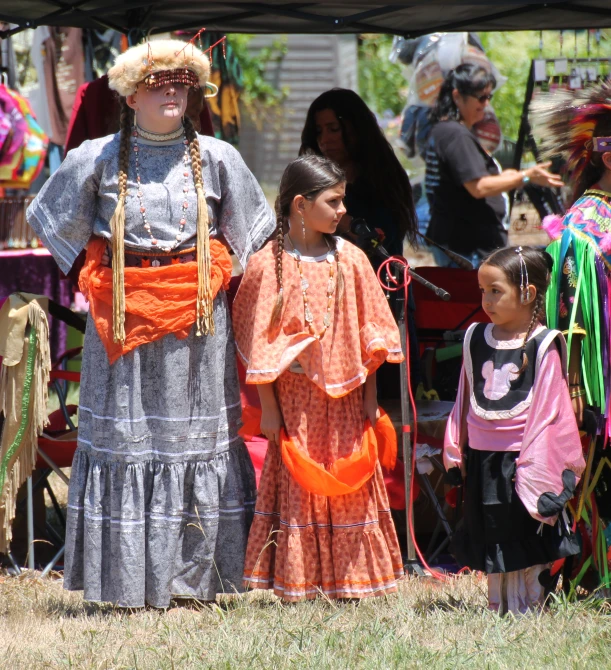 a group of children in costume, some with dolls