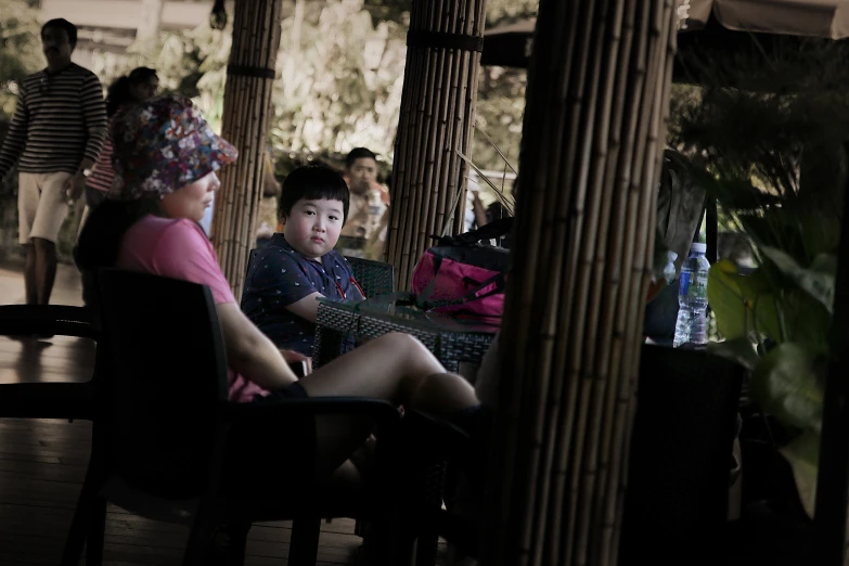 two young women sitting next to each other on a porch