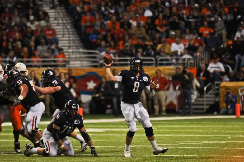 a football player throws the ball in a game