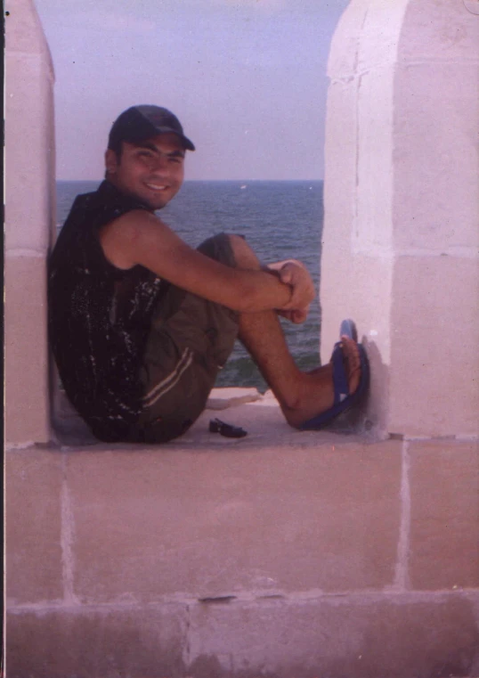 a man sitting in the window and posing for the camera