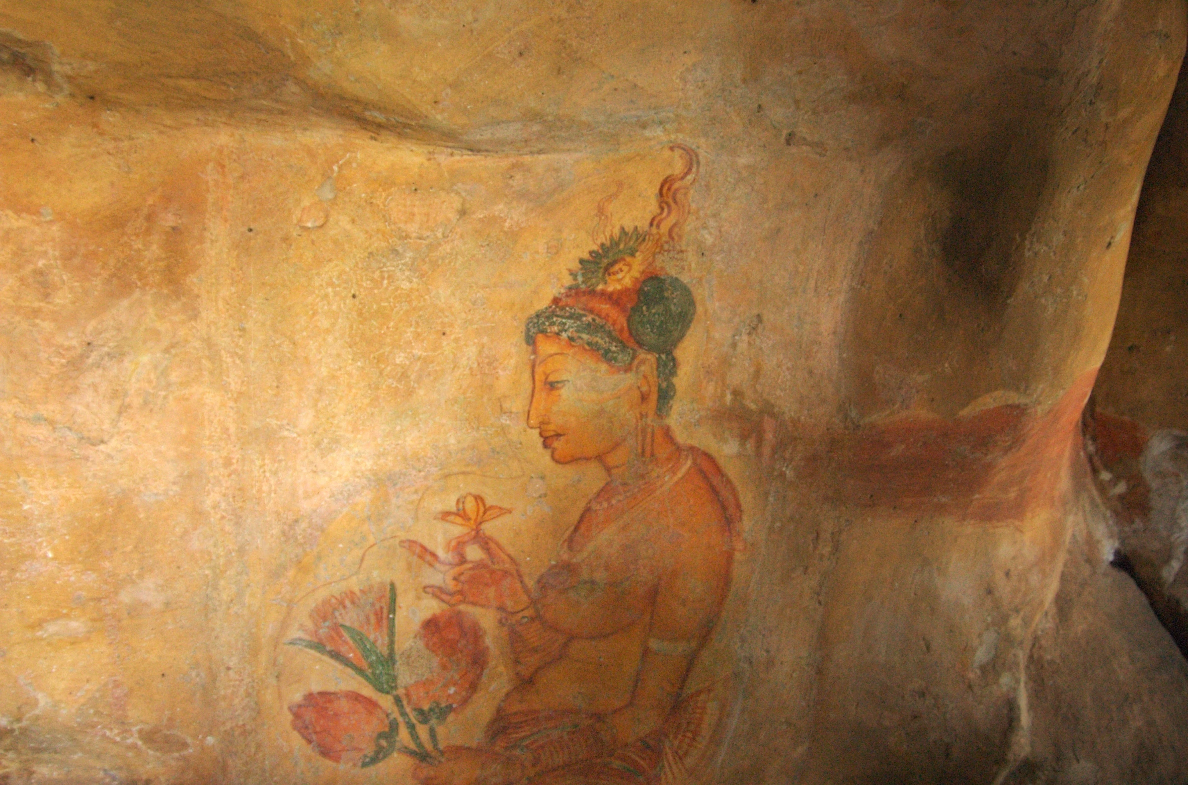 a large cave like structure with painted images on it