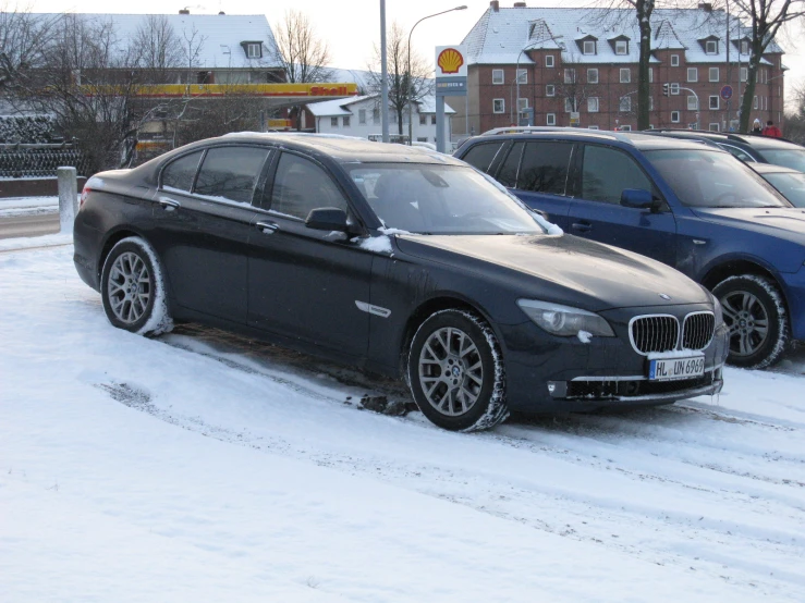 two vehicles parked next to each other on snow covered road