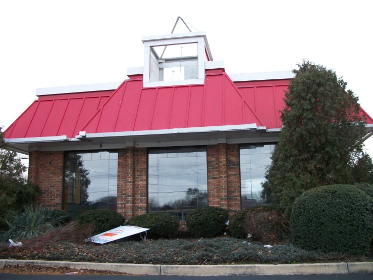 a red roof sits on top of the store