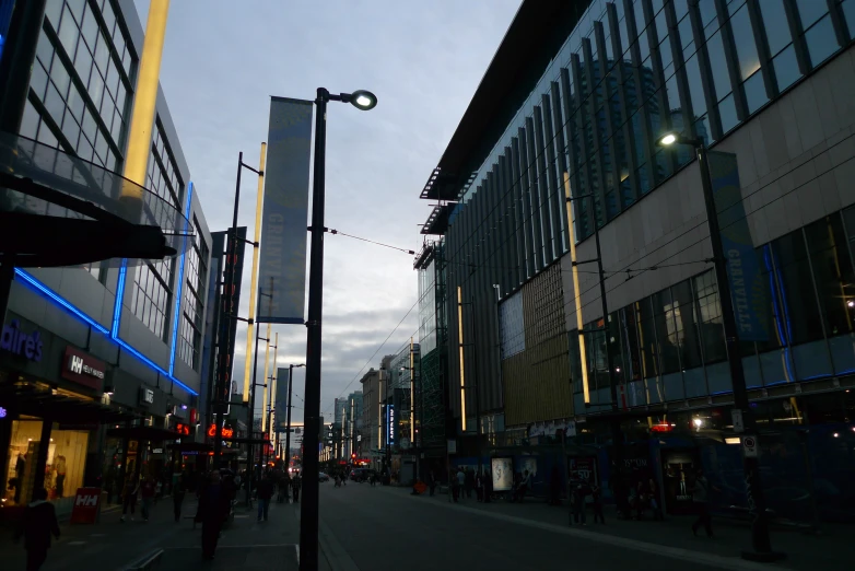 pedestrians crossing the street in a city at night