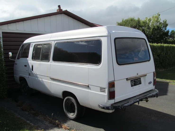 an old vw camper van is parked on a driveway