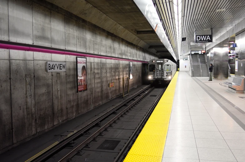 a train is traveling down some tracks at the subway station