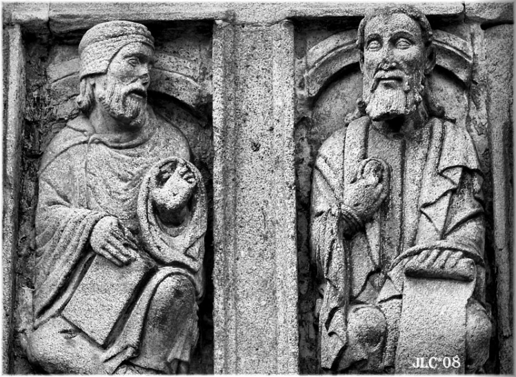 a stone carving depicting two people holding items